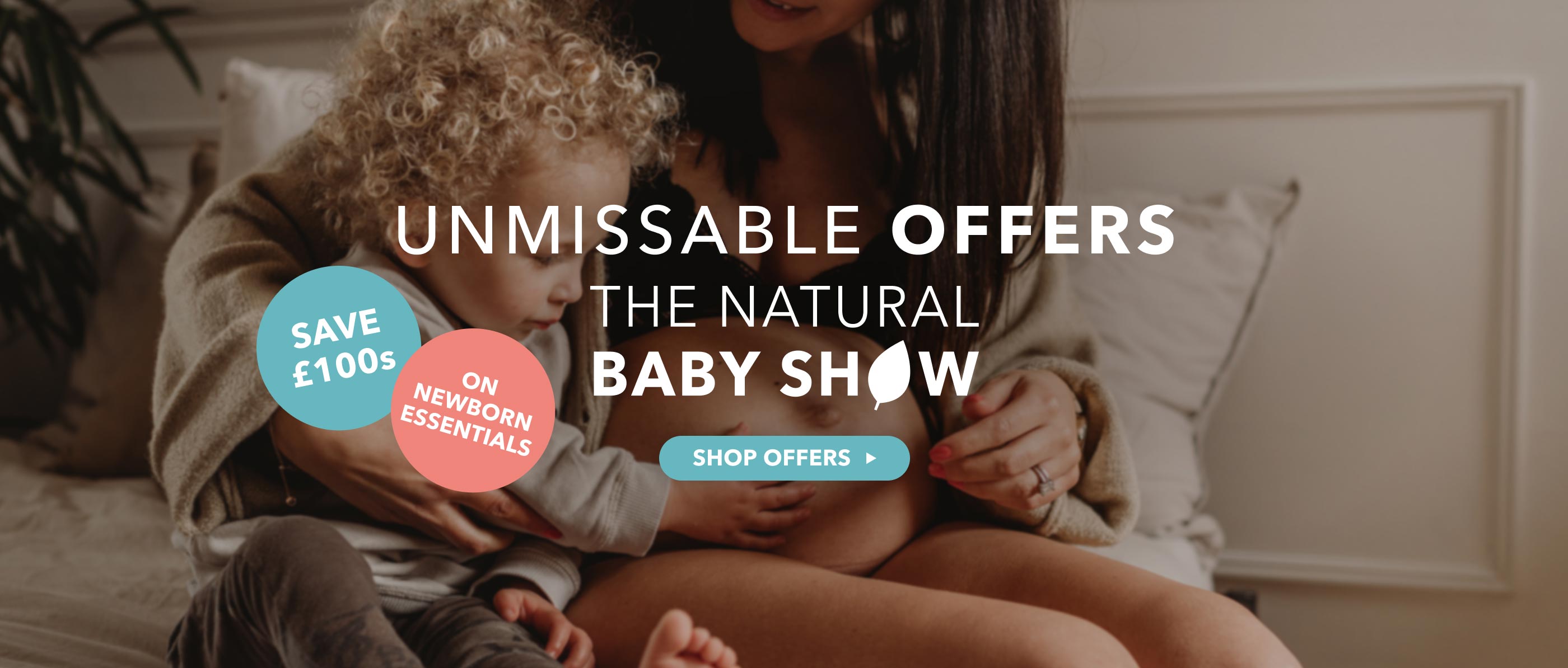 Woman holding a child with promotional text for The Natural Baby Show on a dark background